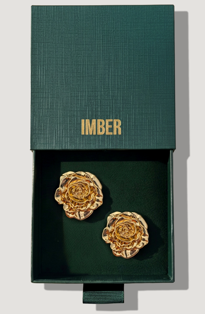 IMBER Rose gold flower stud earrings in open green gift box, top view