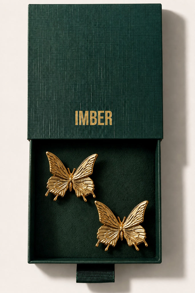 IMBER Butterfly gold butterfly stud earrings in open green gift box, top view