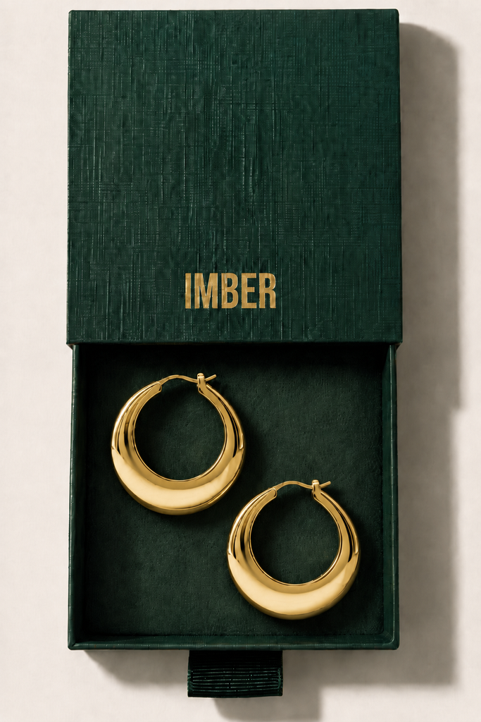 IMBER Chunky Hoops gold hoop earrings in open green gift box, top view