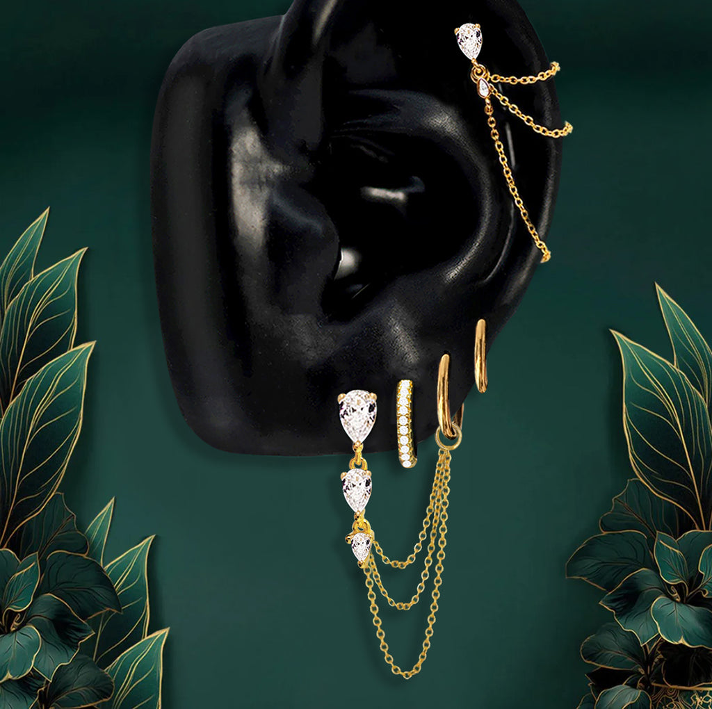 Gold dangle earrings with teardrop stones and chain design