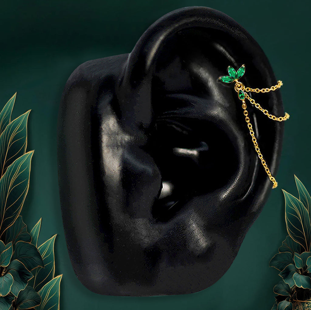 Flat back helix earrings in gold finish with emerald green gems designed for comfort and security