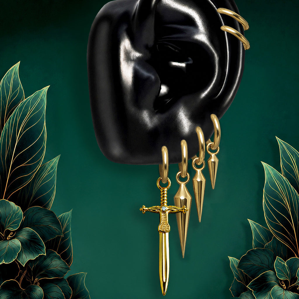 IMBER Ascendant gold waterproof earring stack with implant grade titanium sword huggies and bold drop charms for a curated ear stack