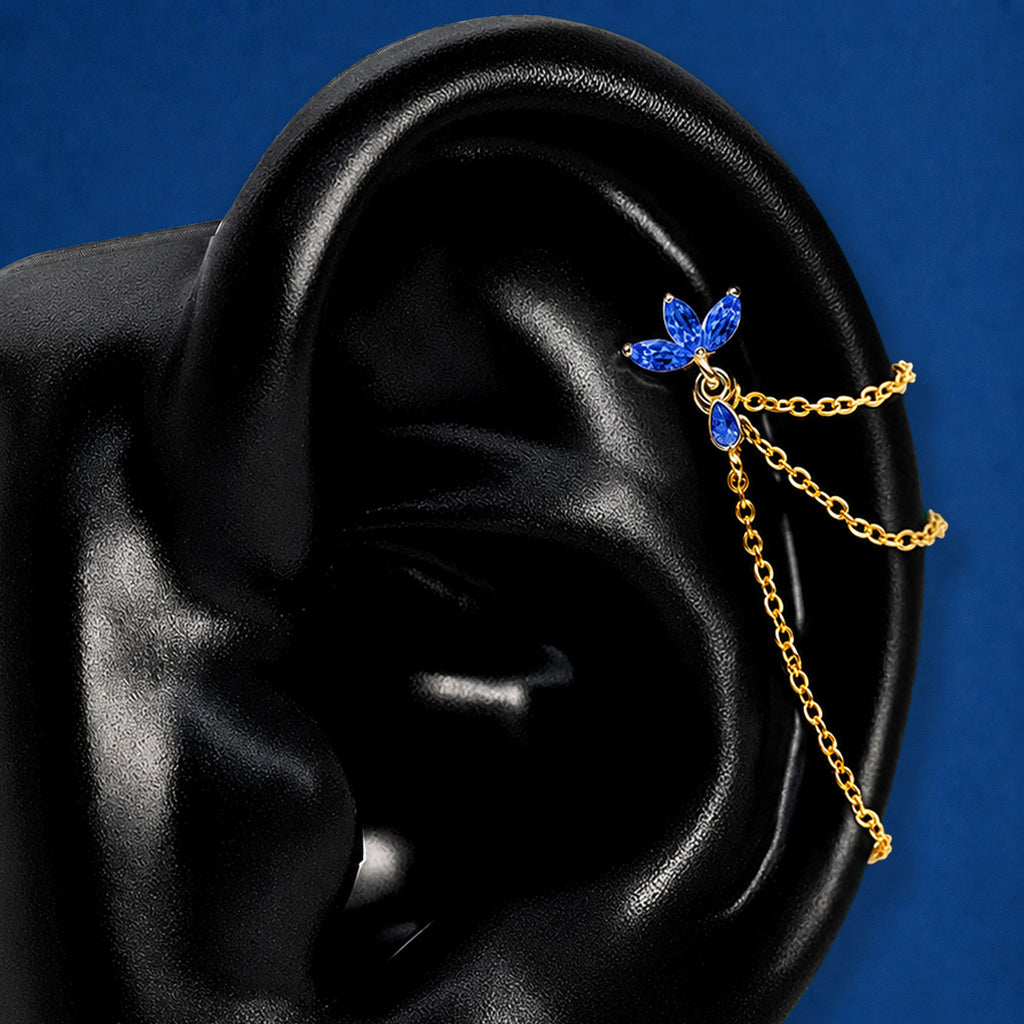 IMBER Eternal blue floral waterproof helix earring in gold with marquise-cut blue stones and three draping chains shown on a black ear display
