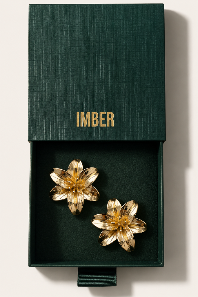 IMBER Lily gold flower stud earrings in open green gift box, top view
