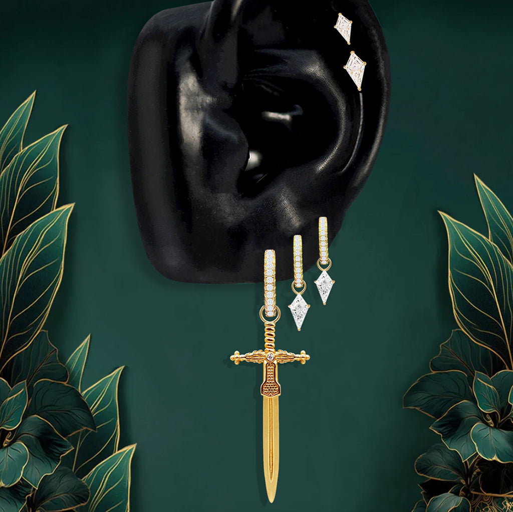 Bold gold statement earrings styled with stacked gold hoops